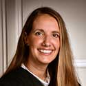 Image of a smiling female judge with long, straight blonde hair