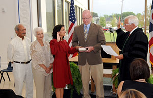 Justice O'Donnell administers the oath of office to Judge Whitman as her husband, Keith, holds the Bible. Standing behind Judge Whitman are her father, Allen Arabian, and her mother, Aggie. Justice O'Donnell administers the oath of office to Judge Whitman as her husband, Keith, holds the Bible. Standing behind Judge Whitman are her father, Allen Arabian, and her mother, Aggie.