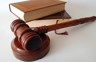 Image of a wooden gavel and some books