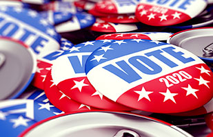 Image of a pile of red, white, and blue metal buttons that say 'Vote 2020' (3dfoto/istock)