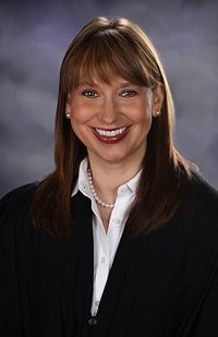 Image of a smiling woman with long, dark hair