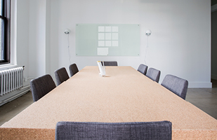 Image of a long, rectangle conference table with chairs