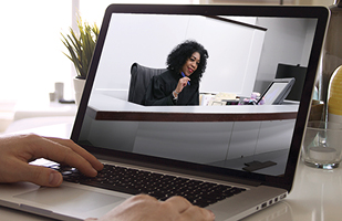 Image of someone viewing a court proceeding on a laptop