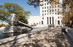 Image of the sculpture of the giant gavel in the south plaza reflecting pool at the Thomas J. Moyer Ohio Judicial Center