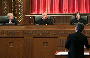 Image of Chief Justice Maureen O'Connor and Justices Paul E. Pfeifer and Judith Ann Lanzinger listening from the bench as an attorney presents oral arguments