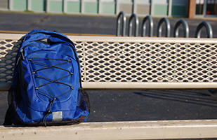 Image of blue backpack on a park bench Image of blue backpack on a park bench