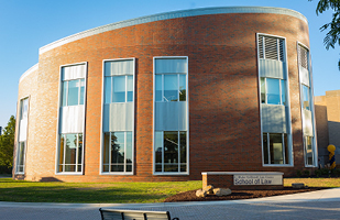 Image of the curved, red brick building of the University of Akron School of Law