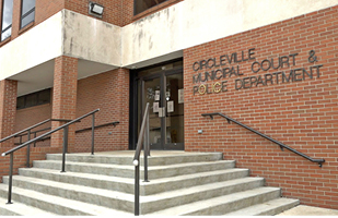 Image of cement steps alongside a brick wall. On the brick wall it says, 'Circleville Municipal Court & Police Department'