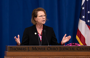 Image of Ohio Supreme Court Chief Justice Sharon L. Kennedy speaking from behind a wooden podium.