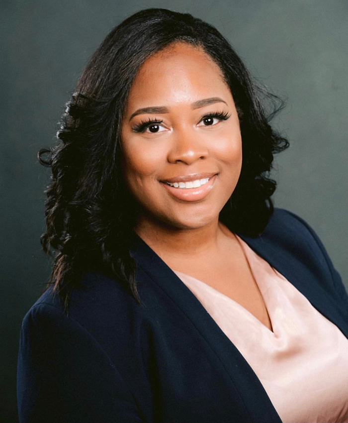 Image of a smiling woman wearing a blue suit