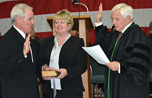 Justice Terrence O'Donnell (right) administers the oath of office to Judge Tim McCormack as McCormack's wife, Valorie, looks on. McCormack will serve on the Eighth District Court of Appeals in Cleveland.