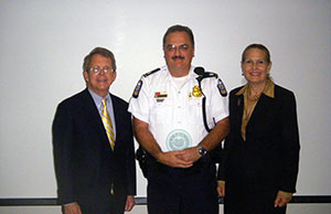 Attorney General Mike DeWine and Supreme Court Justice Evelyn Lundberg Stratton congratulate Columbus Police Department Cmdr. Chris Bowling, who received the first Evelyn Lundberg Stratton CIT Champion of the Year award on September 5.