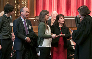 Image of Ohio Supreme Court Justice Judith L. French taking the oath of office administered by Ohio Supreme Court Chief Justice Maureen O'Connor as Justice French's family looks on
