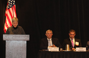 Image of Ohio Supreme Court Chief Justice Maureen O'Connor speaking from a podium and Nevada Justice James Hardesty, and Professor Sam Kamin seated at a table nearby (Photo Credit: Michael Sommermeyer)