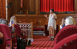 Image of Ohio Supreme Court Justice Melody Stewart standing in the courtroom of the Thomas J. Moyer Ohio Judicial Center speaking to a group of men and women