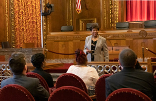Image of Ohio Supreme Court Justice Melody J. Stewart standing in the courtroom at the Thomas J. Moyer Ohio Judicial Center speaking to a group of people