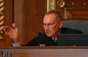 Image of Court of Claims Judge Patrick M. McGrath engaging in oral arguments from the bench in the courtroom of the Thomas J. Moyer Ohio Judicial Center