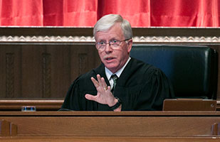 Image of a male judge engaged in oral arguments in the courtroom of the Thomas J. Moyer Ohio Judicial Center