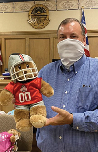 Image of a man holding a teddy bear
