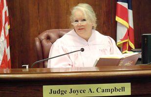 Image of a female judge wearing a pink judicial robe