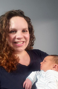 Image of Judge Michelle Fisher holding her newborn son