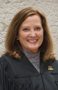 Image is a headshot photo of Tenth District Court of Appeals Judge Lisa L. Sadler in her black judicial robe