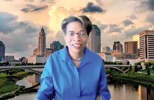 Image of Ohio Supreme Court Justice Melody Stewart with the Columbus skyline behind her