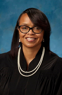 Image of a female judge wearing a black judicial robe