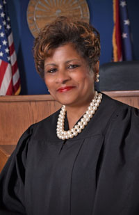 Image of an African American female woman wearing a black judicial robe