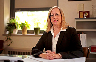 Image of Diana Stevenson sitting at a desk.