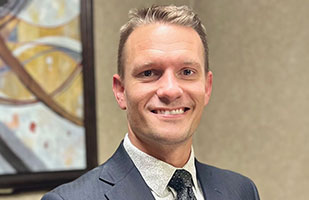 Image of a man wearing a blue blazer.