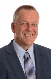 Image of a man wearing a blue plaid suit.