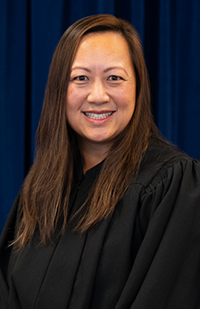 A woman in a judicial robe smiling