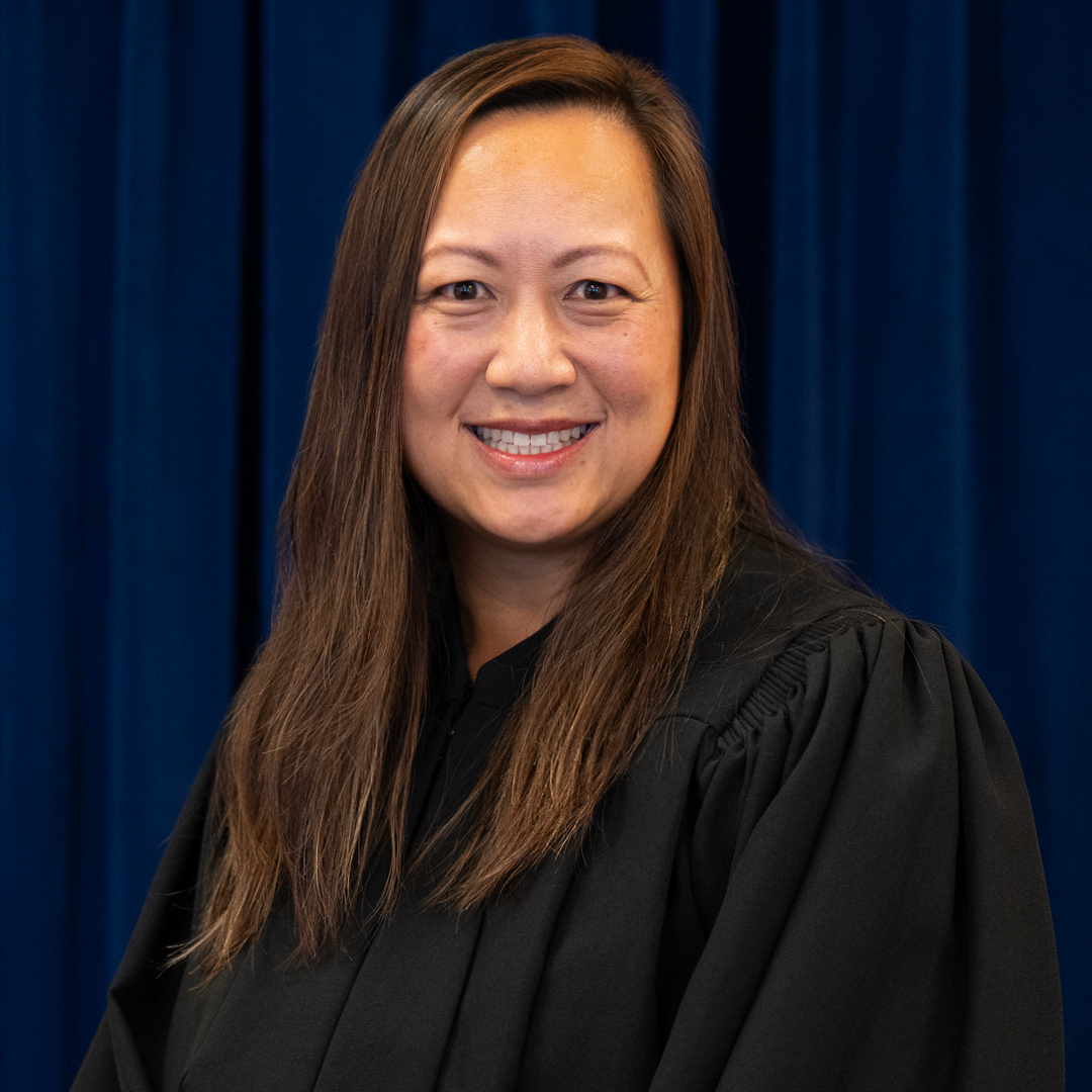 A woman in a judicial robe smiling