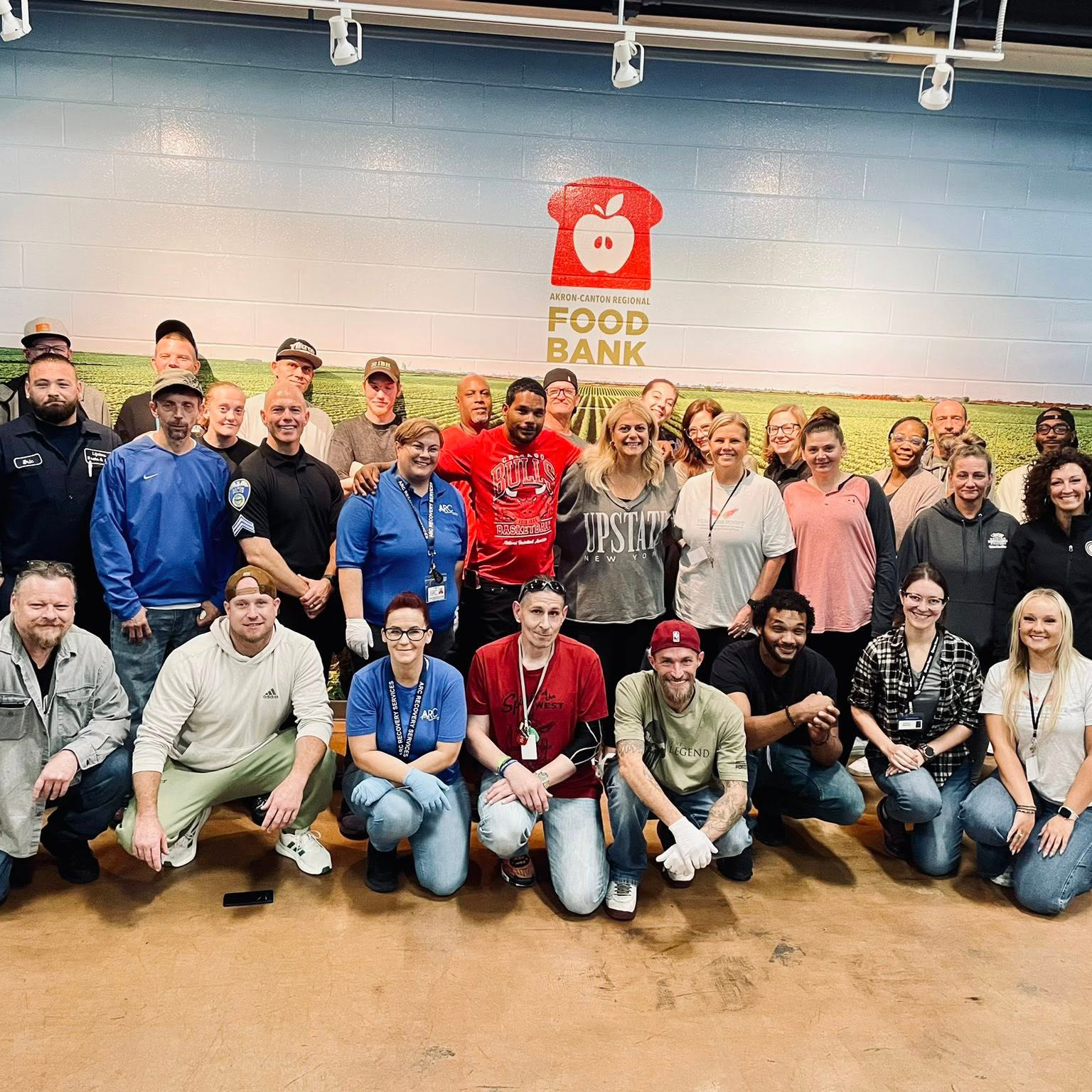 A large group of men and women smiling