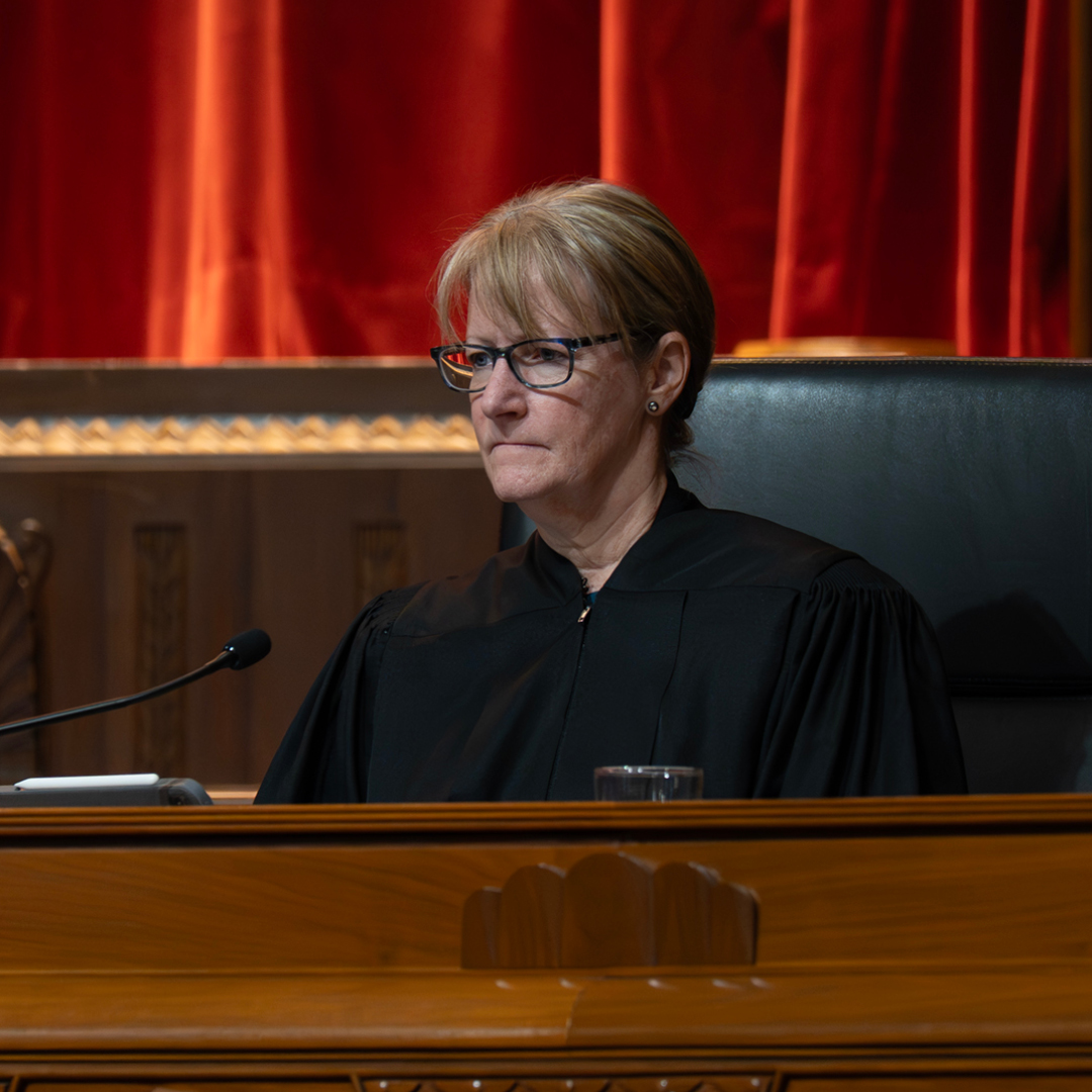 A woman in a judical robe sitting on the bench in the Thomas J. Moyer Ohio Judical Center