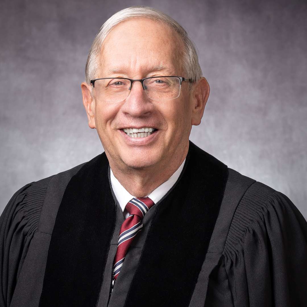 Female judge wearing a black judicial robe.