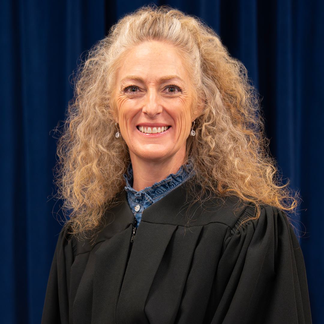 A woman in a judicial robe smiling