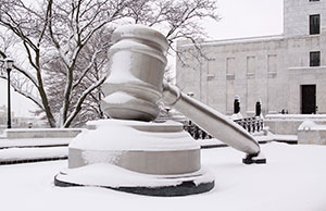 Image of a snow-covered gavel in the south plaza of the Thomas J. Moyer Ohio Judicial Center