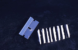 Image of lines of cocaine and a razor blade.