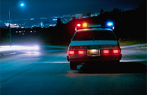 Image of a police cruiser with its emergency lights on