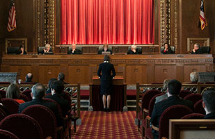 Image of a female attorney standing at a podium presenting oral arguments before the Ohio Supreme Court