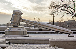 Image of the snow-covered, giant gavel in the south plaza of the Thomas J. Moyer Ohio Judicial Center
