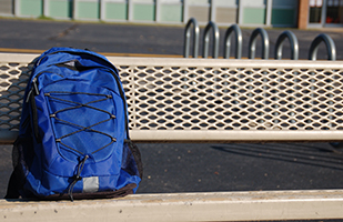Image of blue backpack on a park bench