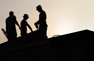 Image of three silhouetted construction workers