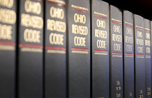 Image of several volumes of the Ohio Revised Code stacked side-by-side