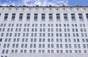 Image is of the white marble Thomas J. Moyer Ohio Judicial Center from the side looking up