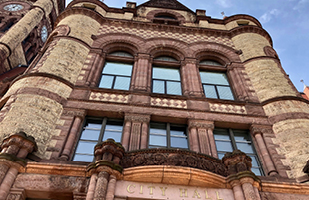 Image of an old building with the words 'City Hall'on it