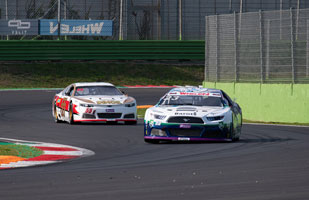 Image of two cars racing on a racetrack