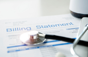 Image of a stethoscope sitting on top of a printout of a billing statement